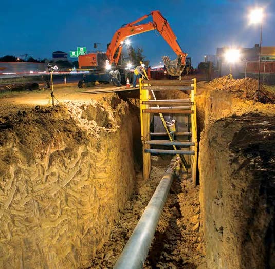 Night excavation and shoring over an exposed distribution main